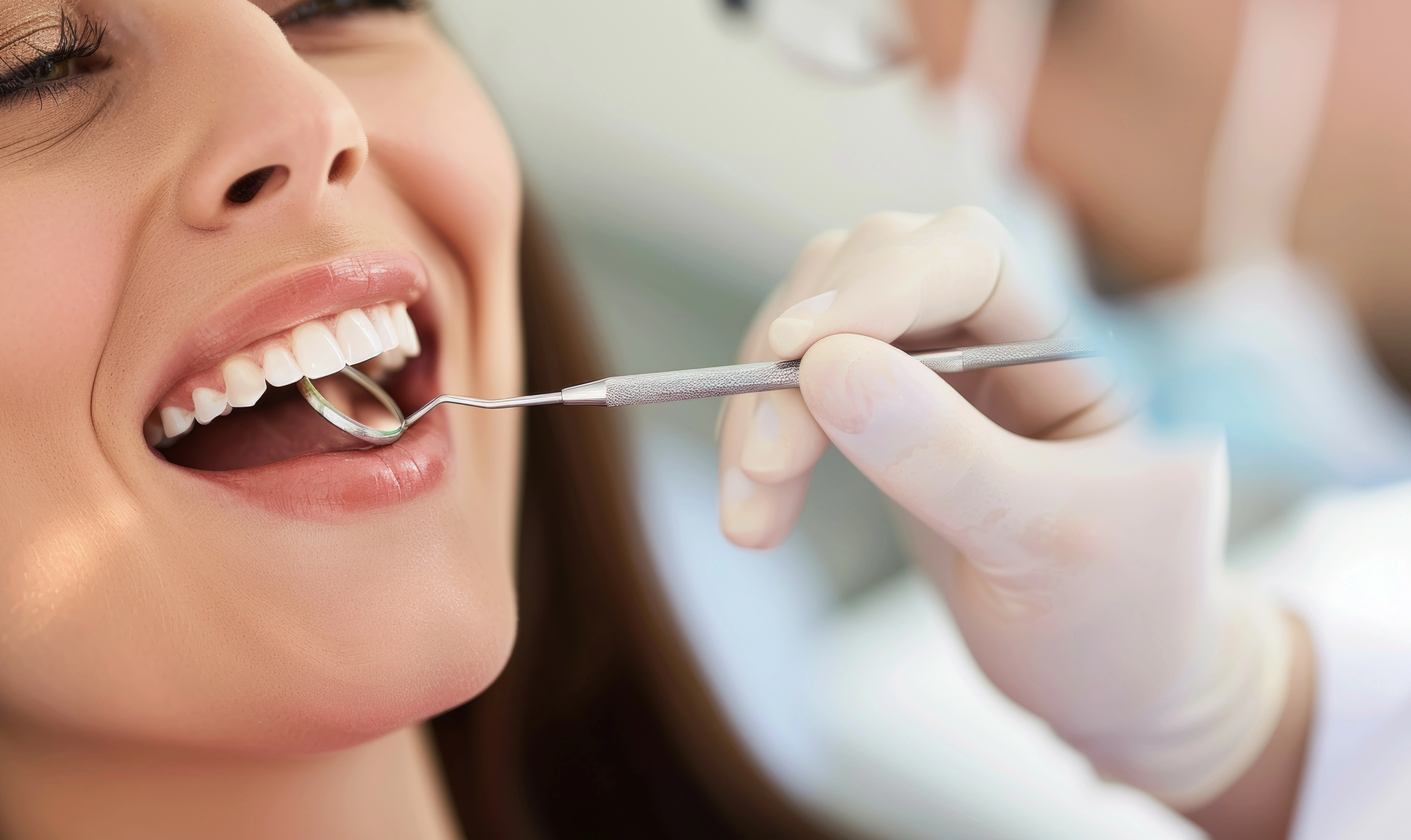 Close-up of female smiling with white teeth during dental examination